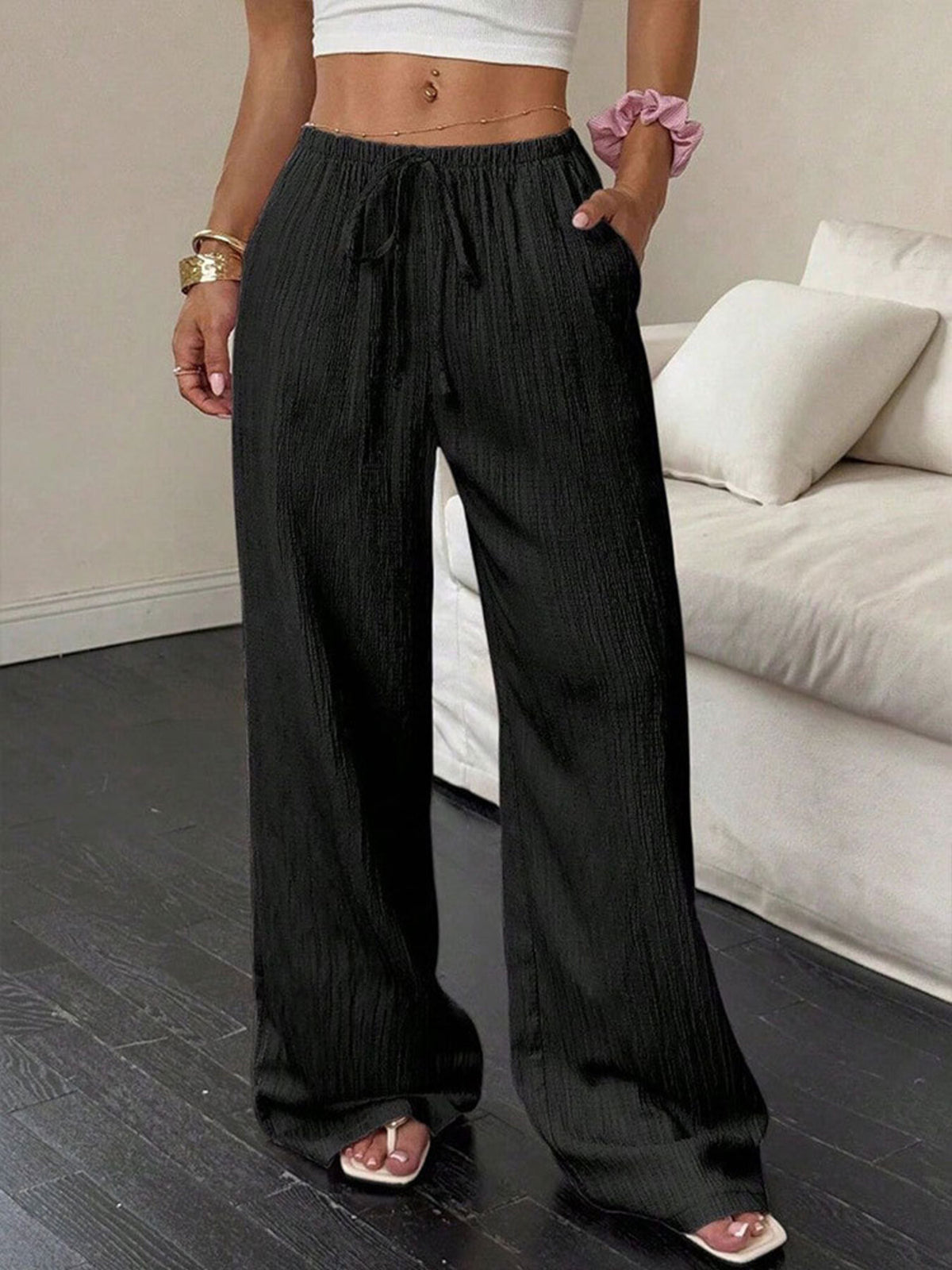 Black crinkled wide-leg pants with drawstring waist and pockets