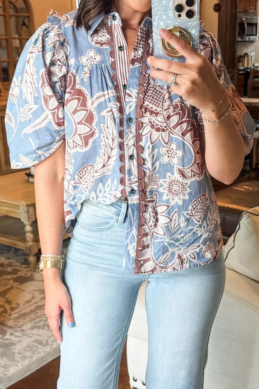 Blue cotton button-up shirt with floral print and scalloped trim detail.