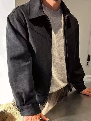 Black zip-up casual jacket with a collar and button cuff, styled over a grey sweater.