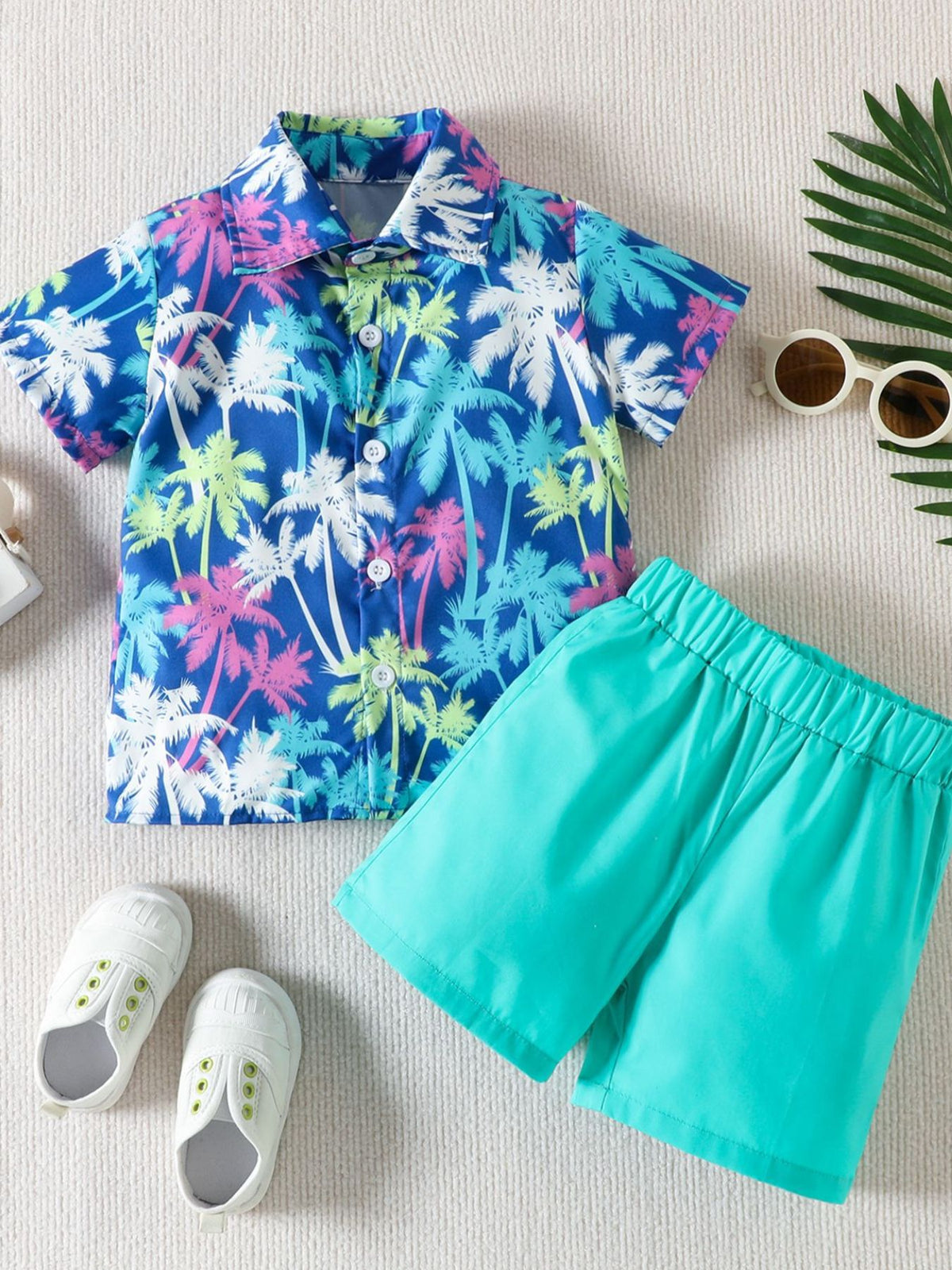 Toddler collared shirt and shorts set with tropical palm tree print and turquoise shorts.