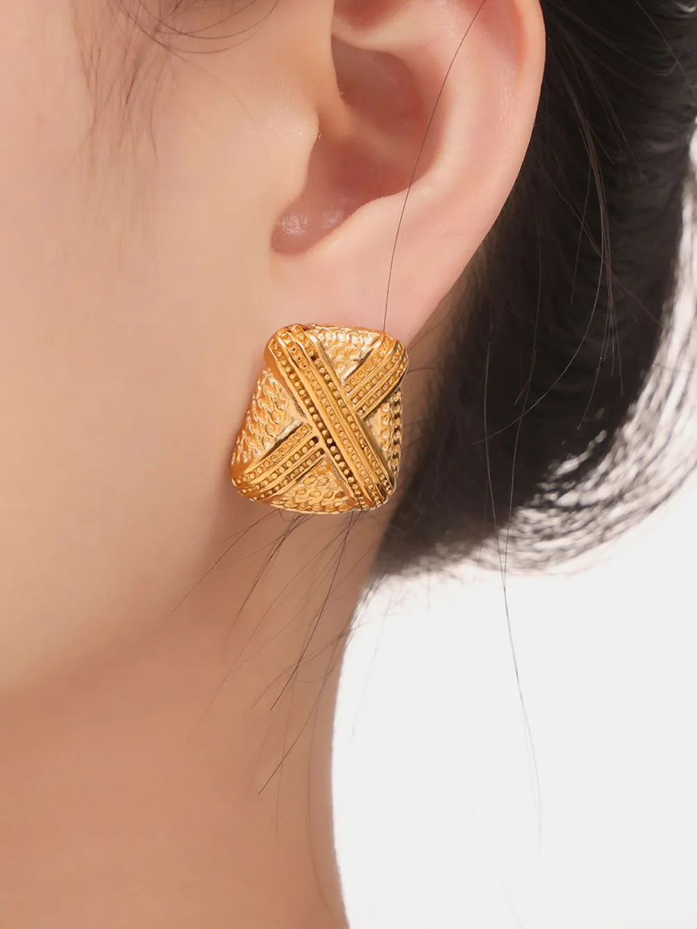Sculptural gold-tone stud earrings with embossed geometric pattern, 18K gold-plated.