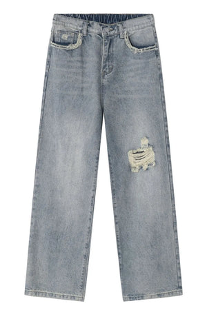 Distressed wide-leg jeans in medium wash denim with raw edge pockets and a ripped detail.
