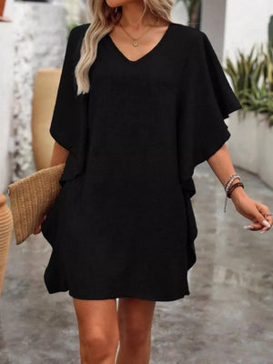 Black V-neck mini dress with flowy sleeves and a relaxed fit.