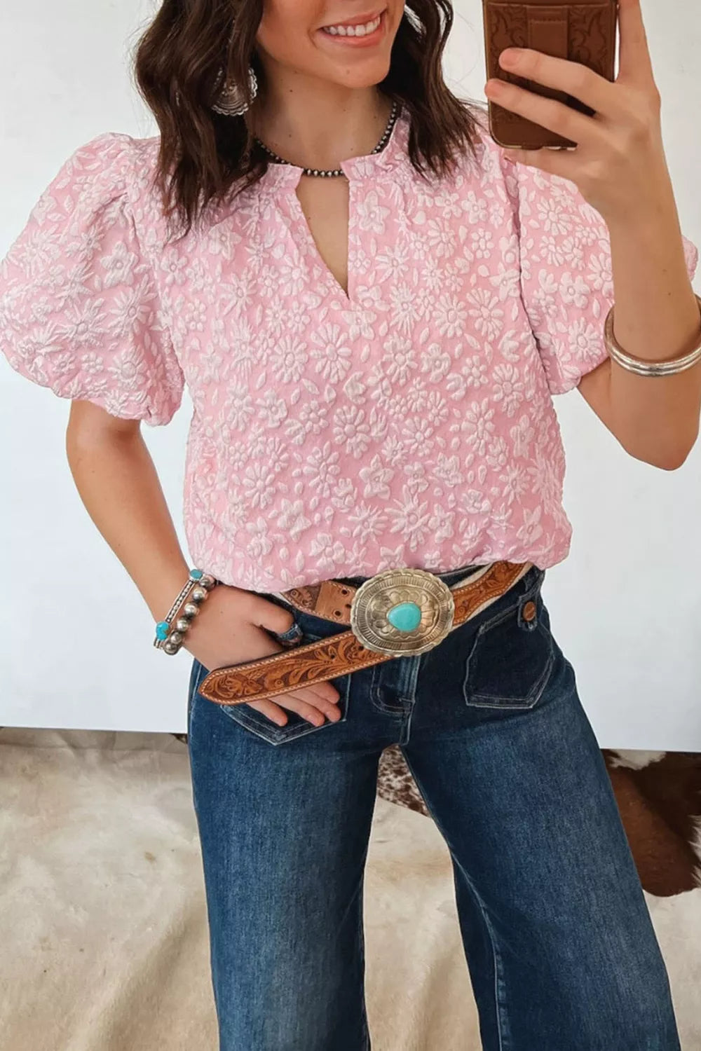 Textured floral puff sleeve maternity shirt in blush pink with a V-neck and short sleeves.