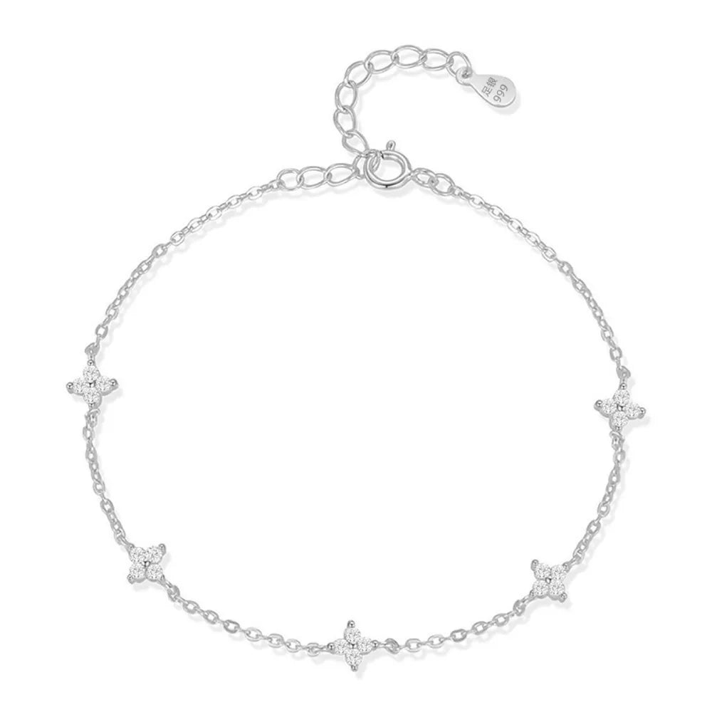 White gold bracelet with delicate clover charms and sparkling stones.