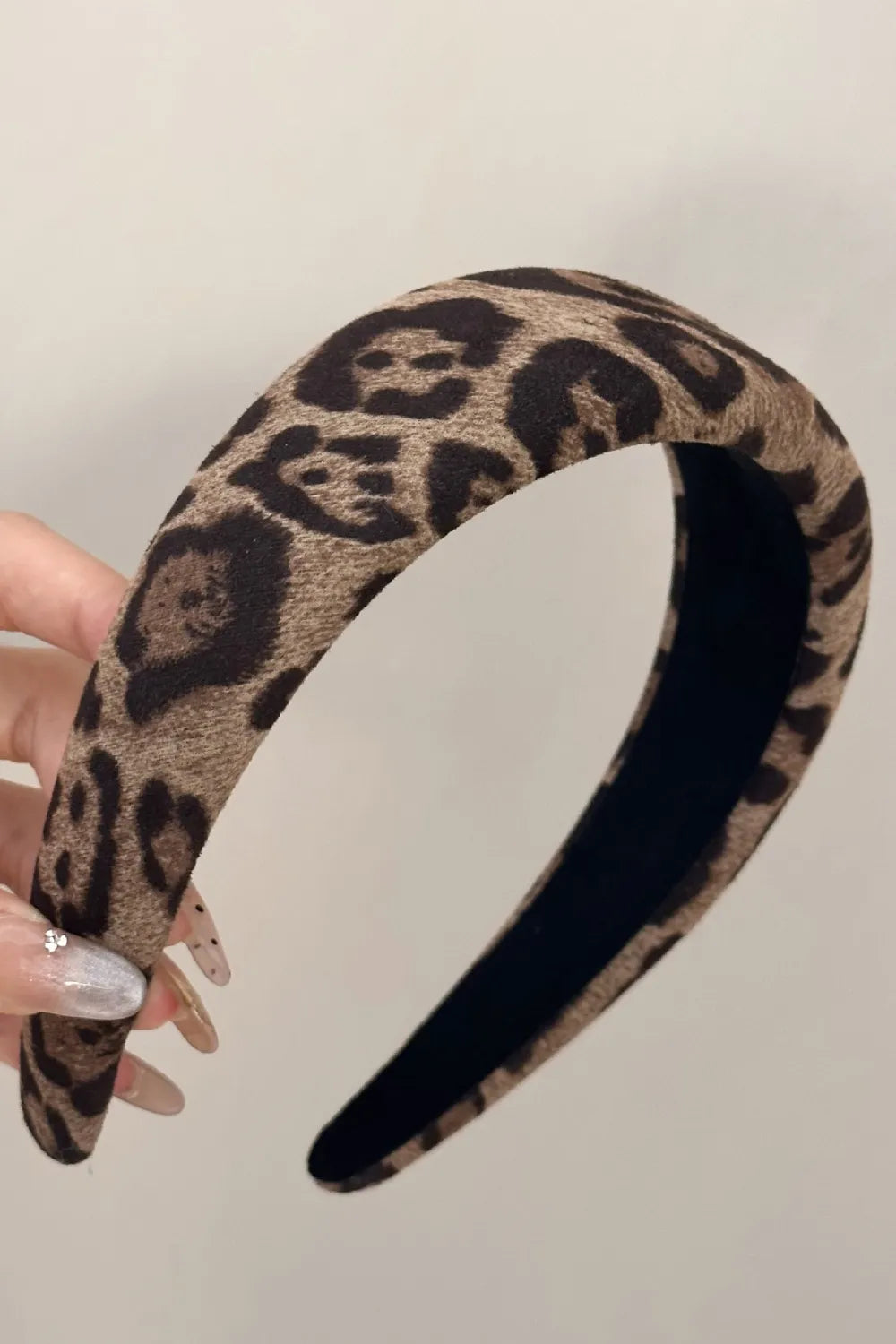 Leopard print knotted headband with a bold design.