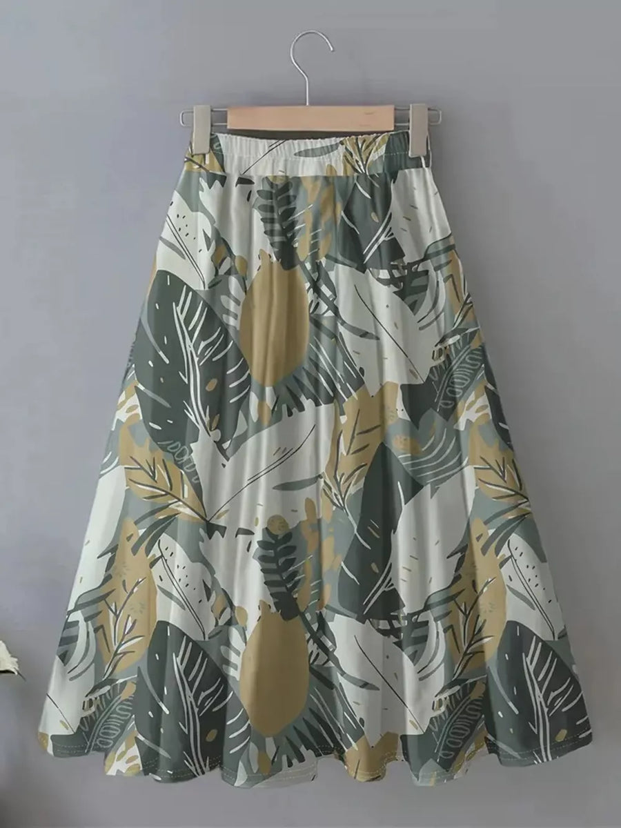 A-line skirt with elastic waist and abstract leaf print in green, olive, and apricot.