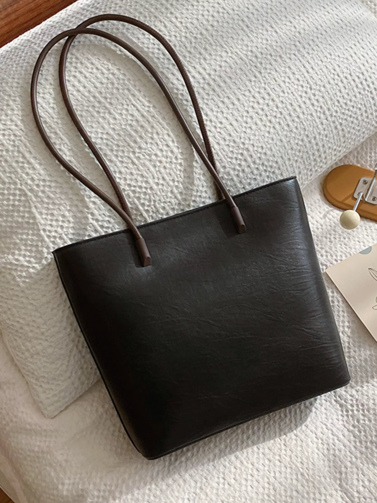 Sleek black PU leather shoulder tote bag with thin brown straps