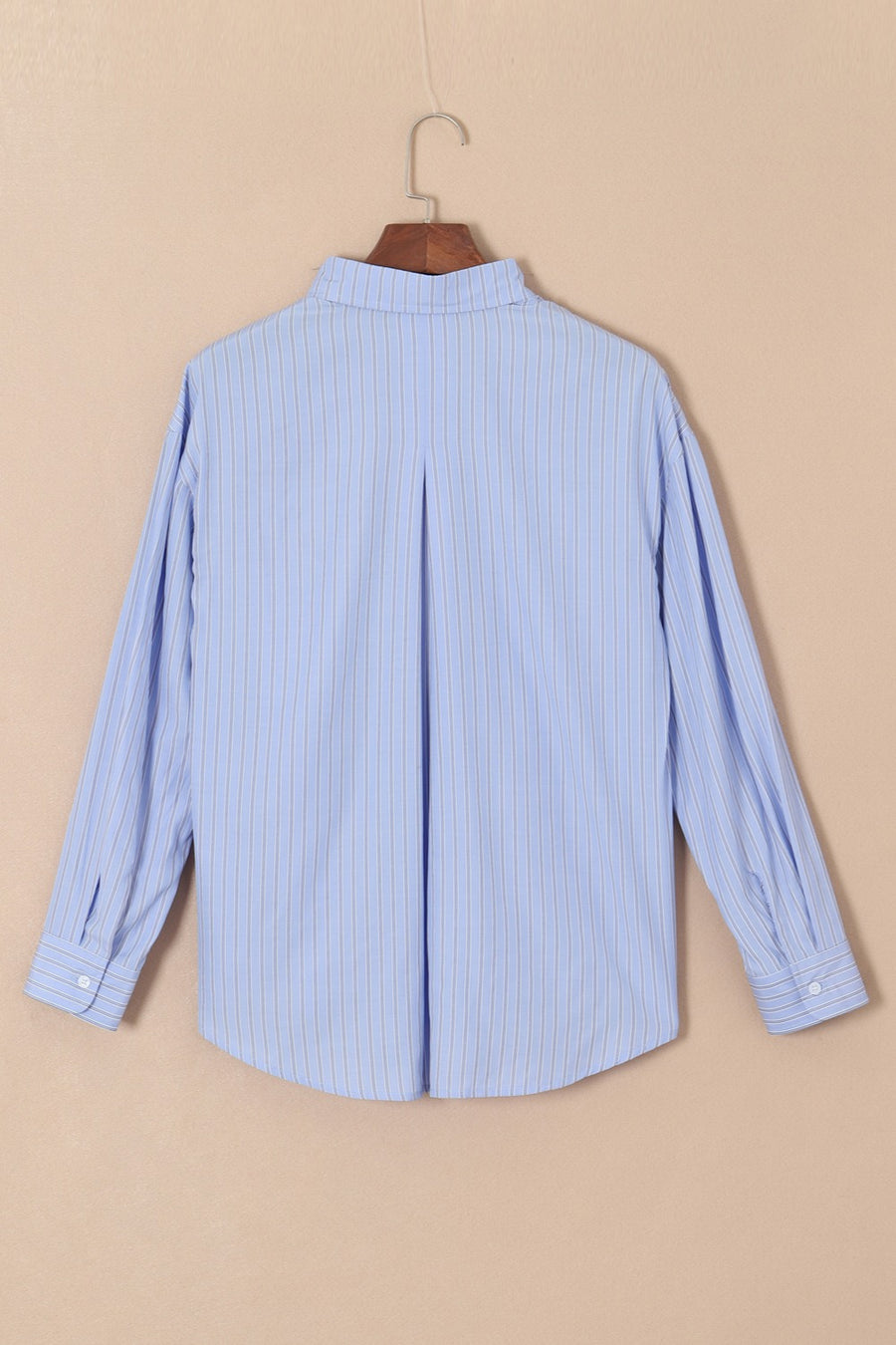 Oversized light blue stripe oxford shirt with buttoned cuffs and back pleat detail.