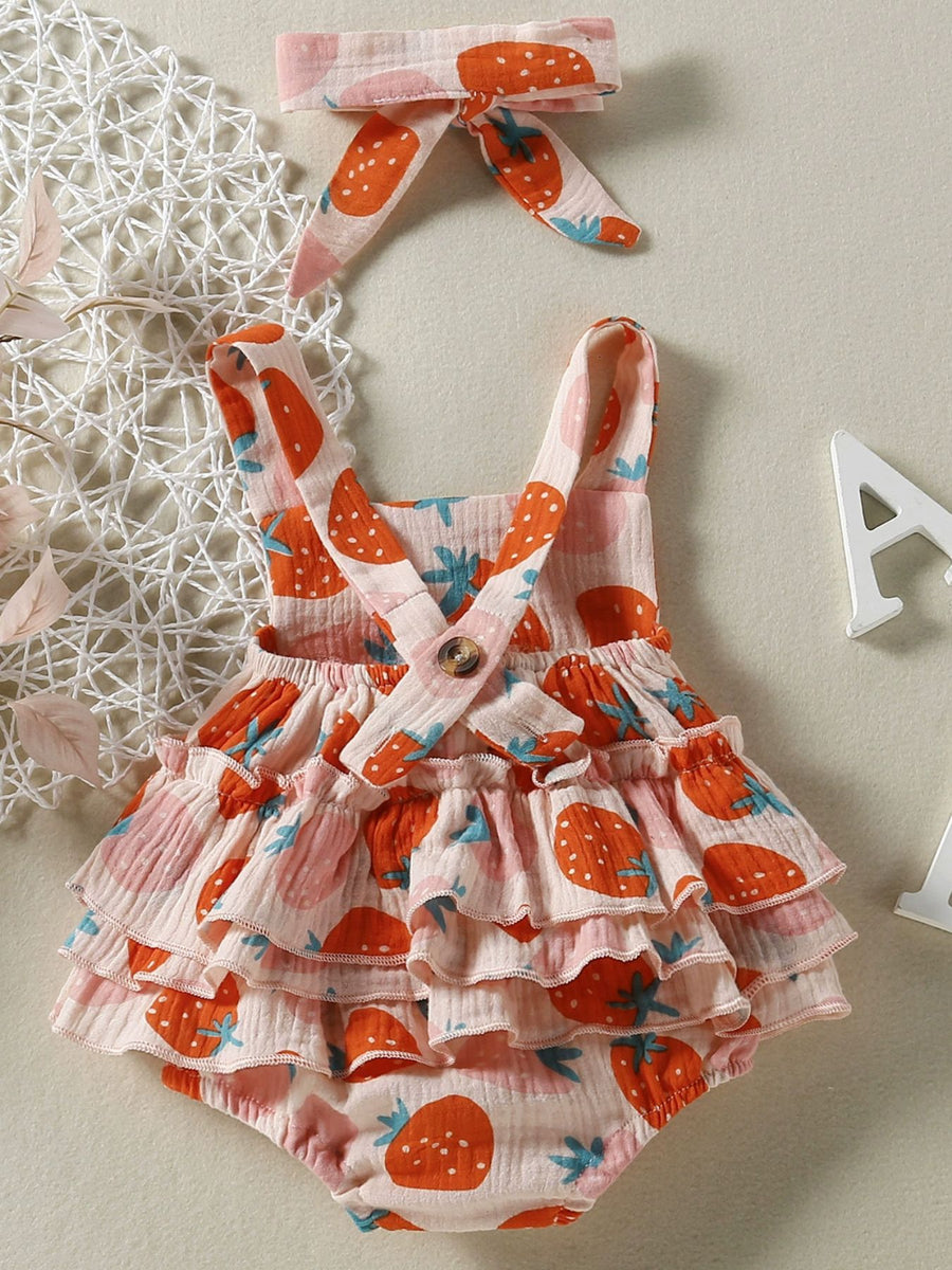 Baby bodysuit with strawberry print, ruffled skirt, and matching headband.
