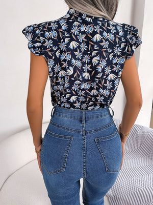Dark blue floral blouse with ruffle sleeves and neck tie detail.