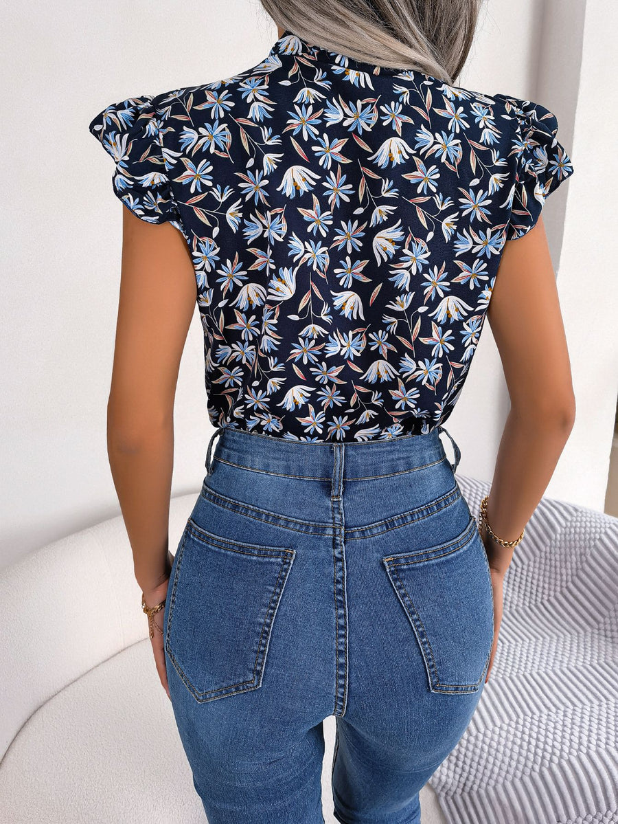 Dark blue floral blouse with ruffle sleeves and neck tie detail.