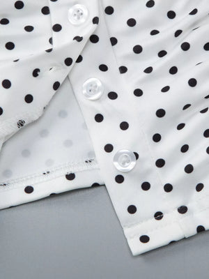 White polka dot t-shirt with button detail and ruched fabric.
