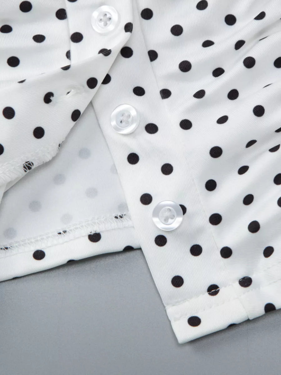 White polka dot t-shirt with button detail and ruched fabric.