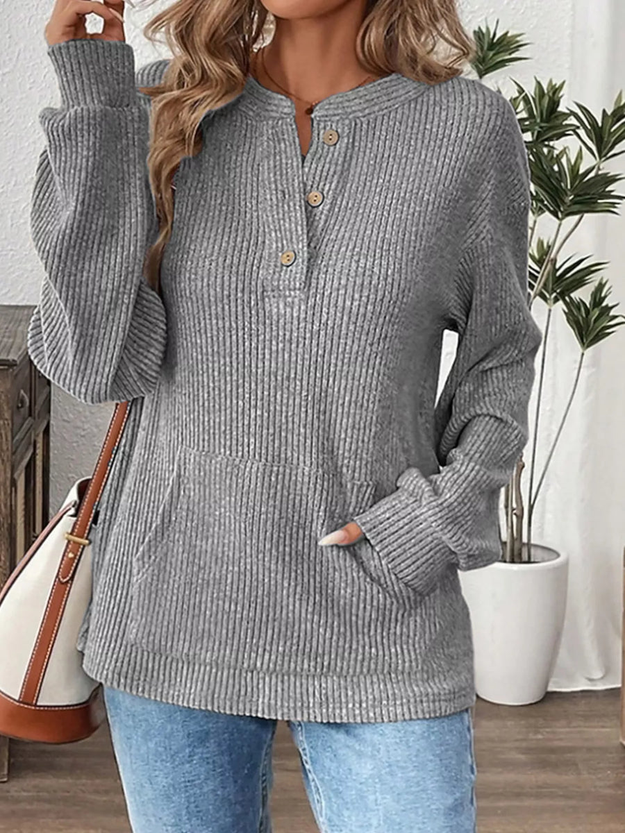 Gray ribbed long-sleeve top with button detail and front pocket.
