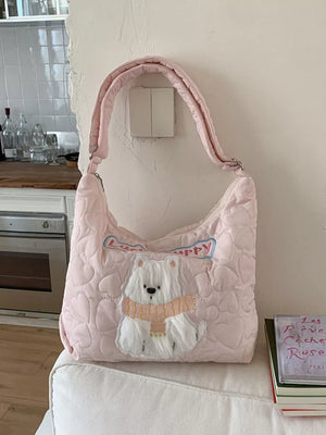 Blush pink quilted crossbody bag with heart pattern and white bear applique.