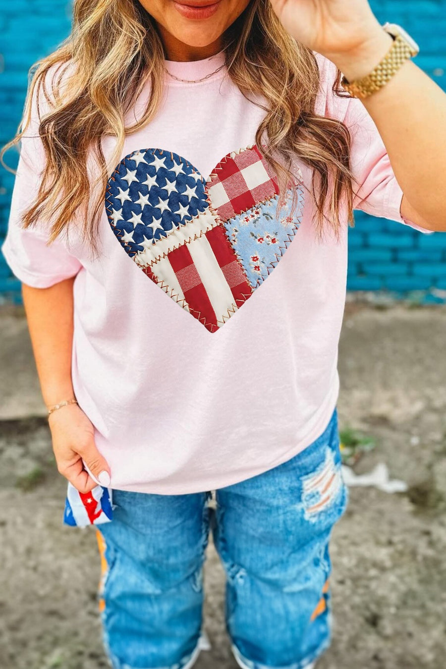 Pink t-shirt with a patriotic patchwork heart graphic on the chest.