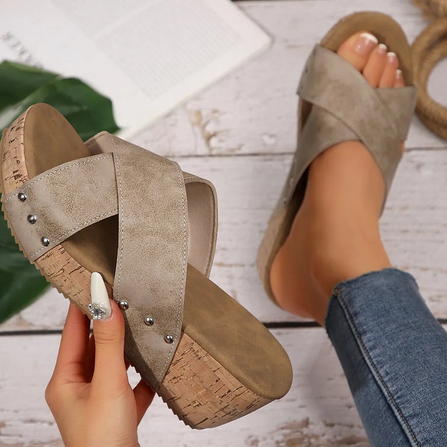 Crisscross studded cork wedge slides in Khaki with a cork wedge heel.