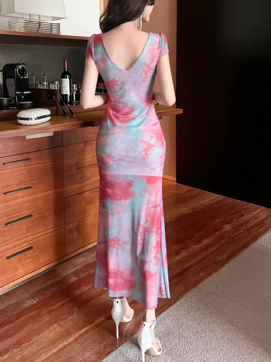 Surplice ruffle maxi dress in pink and blue tie-dye with short sleeves and a V-neck.