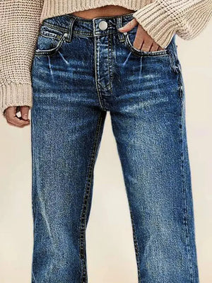 Dark blue denim straight leg jeans with vintage wash and button fly.