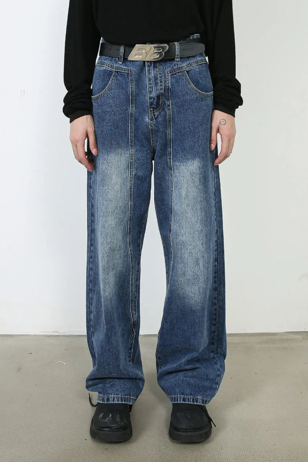 Panel seam wide leg denim jeans in medium blue wash with a relaxed fit.