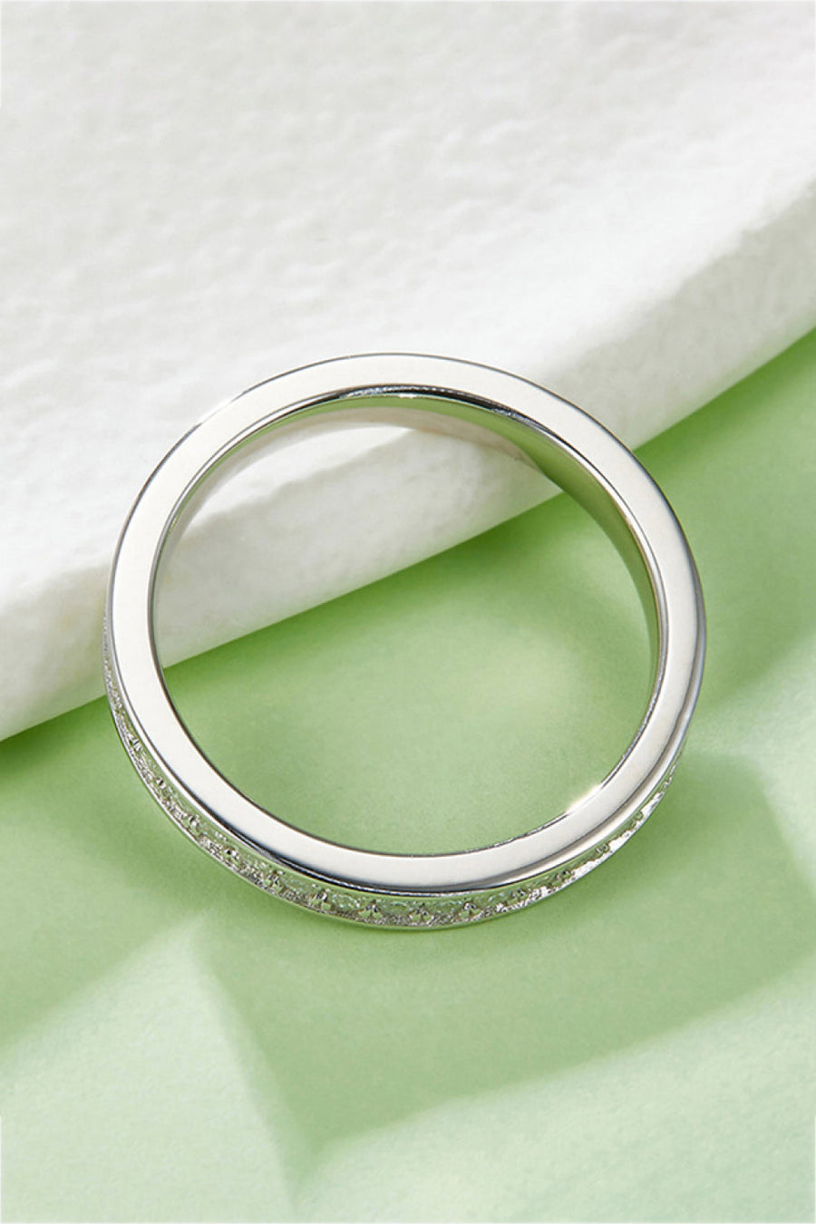 Silver pavé moissanite eternity band ring made of 925 sterling silver.