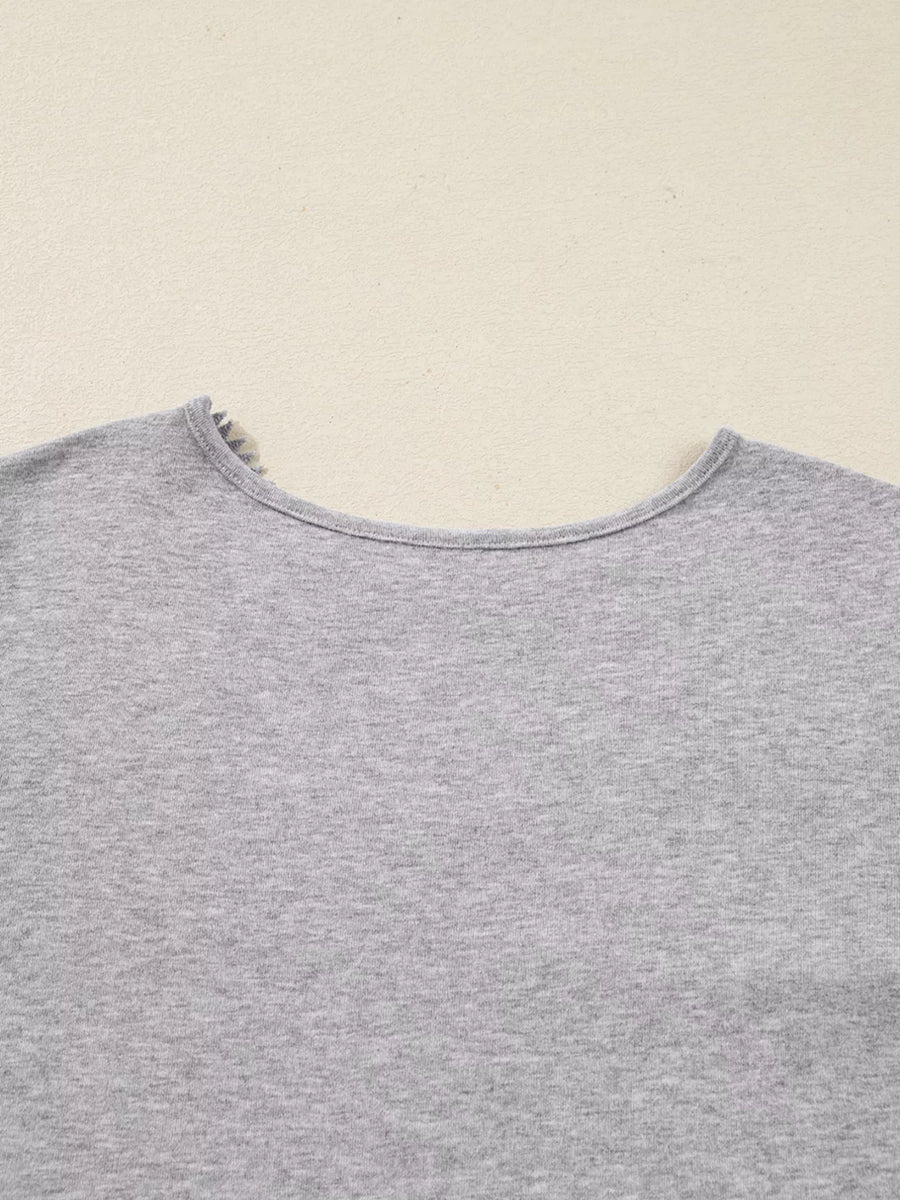 Gray ribbed knit long-sleeve top with delicate lace trim at the neckline.