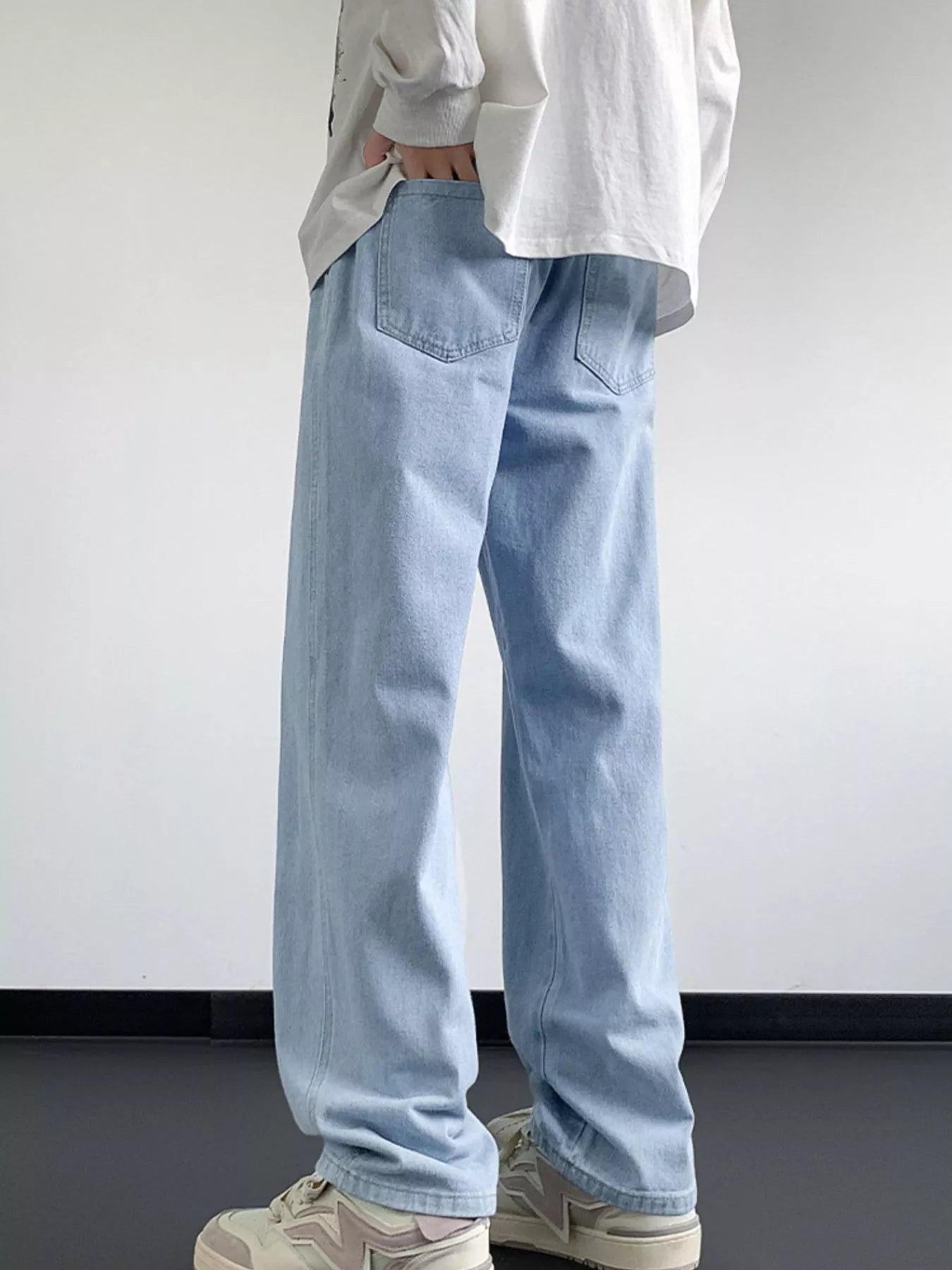 Light blue oversized drawstring jeans with a loose fit and classic back pockets.