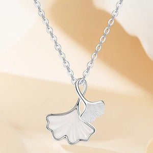 pearlescent white necklace featuring pendant and ginkgo leaf motif
