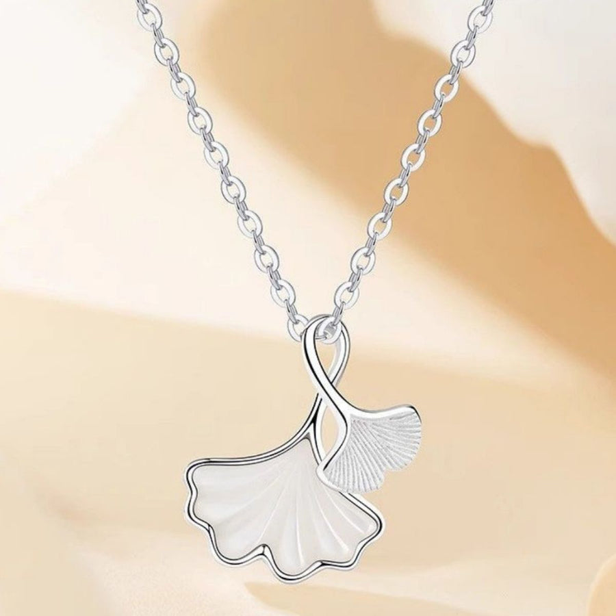 pearlescent white necklace featuring pendant and ginkgo leaf motif