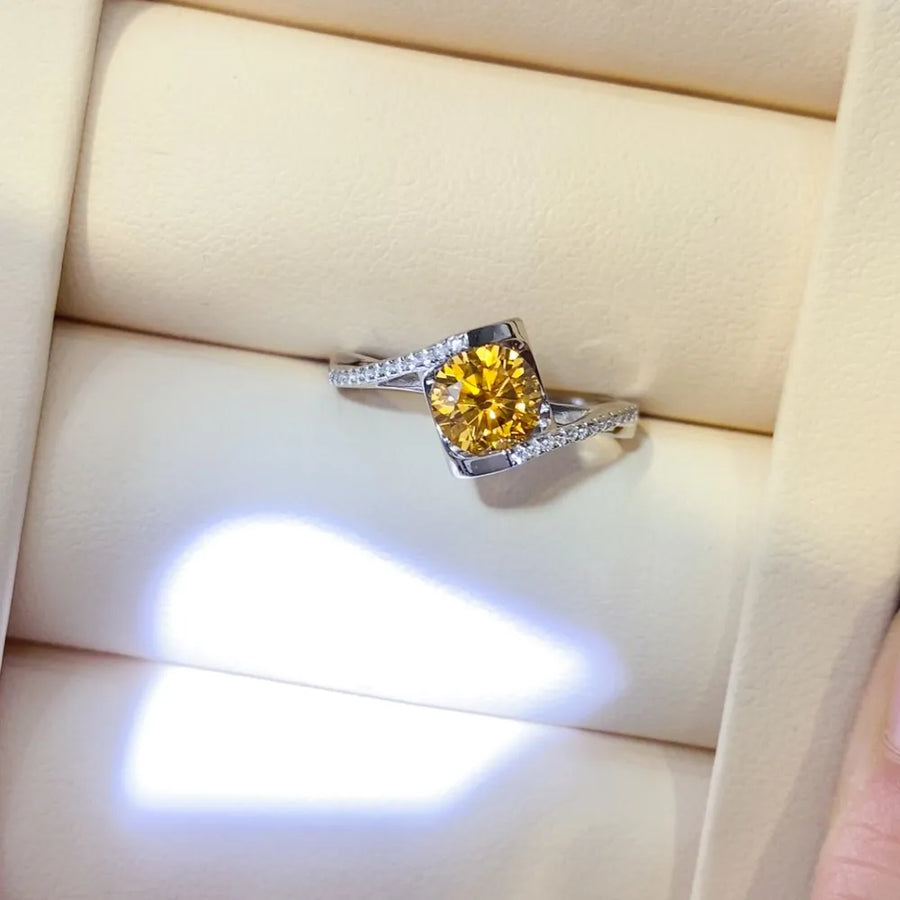 Silver twist ring with a radiant yellow moissanite and diamond accents
