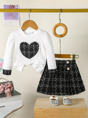 White baby girl's long sleeve top with plaid heart and matching plaid skirt.