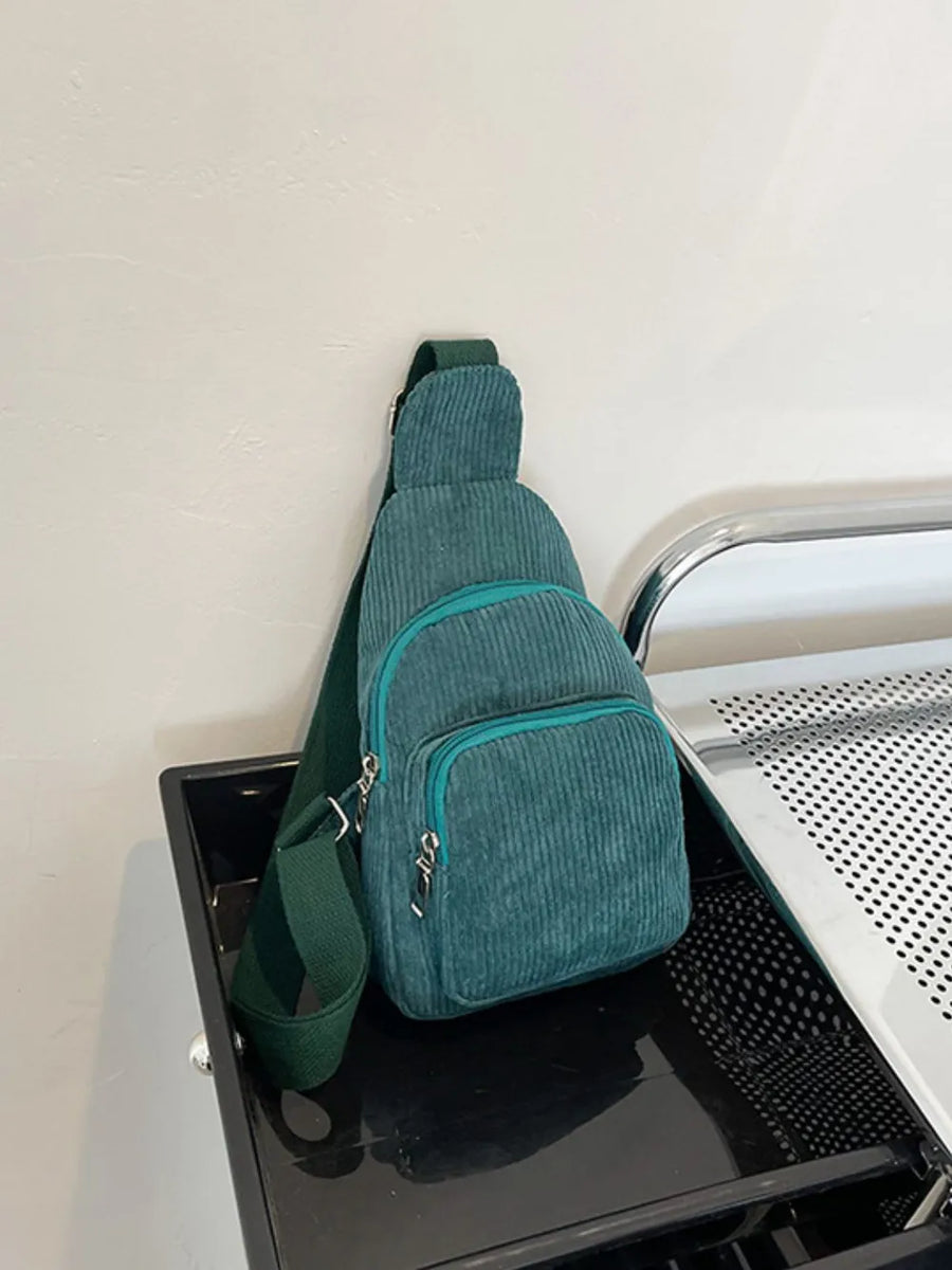 Deep Teal corduroy sling bag with zip pockets and adjustable strap