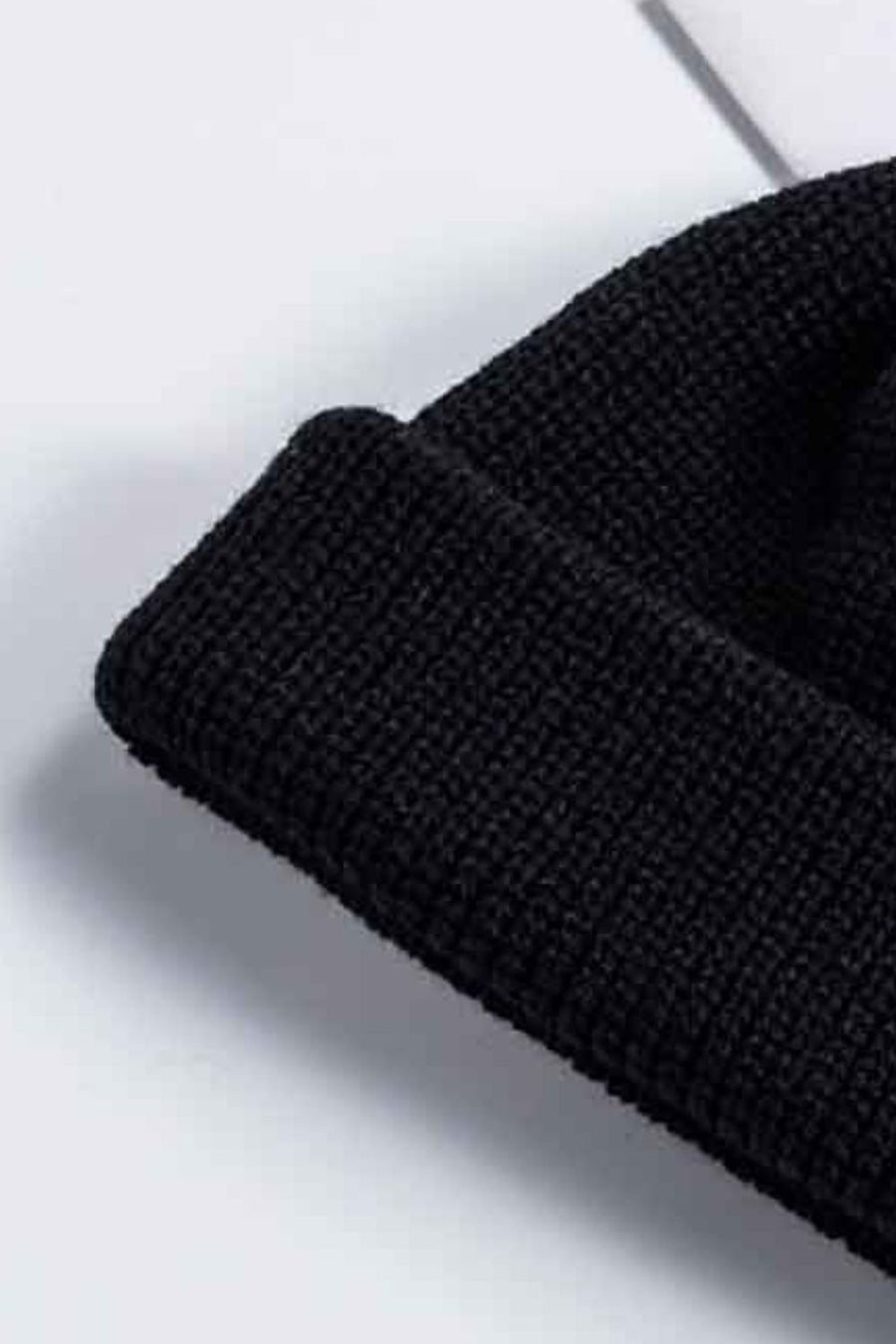Black ribbed knit beanie with a turn-up cuff