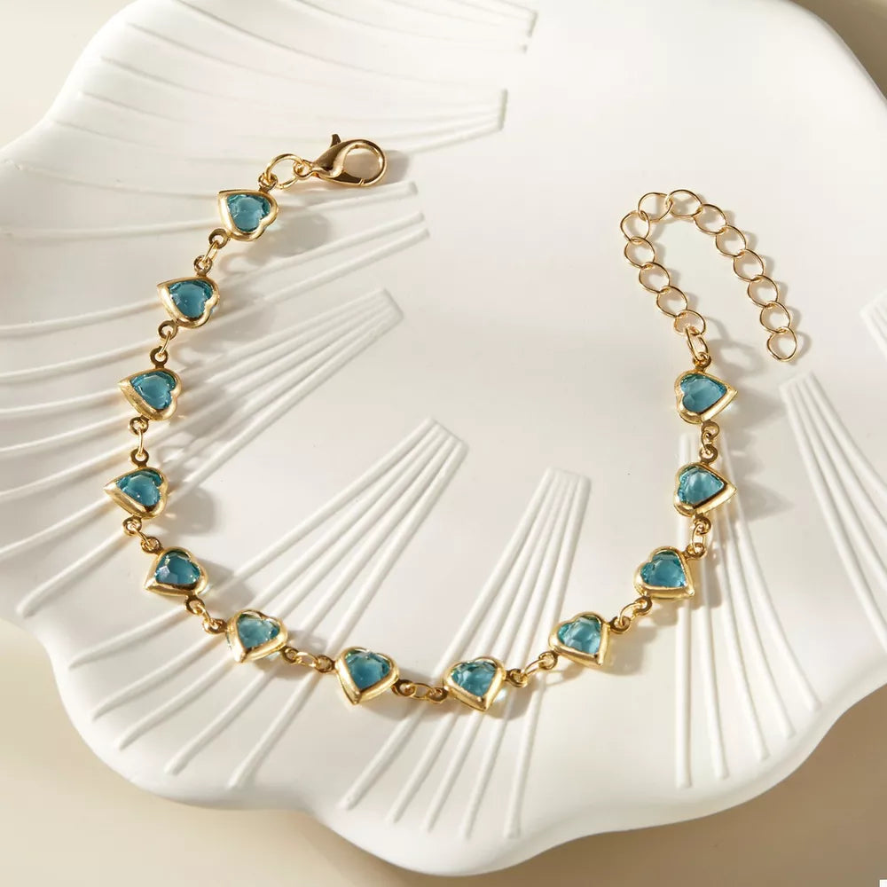 teal bracelet featuring adjustable length and heart-motif