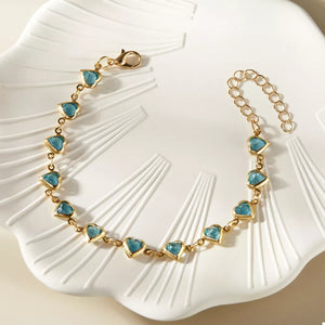 teal bracelet featuring adjustable length and heart-motif
