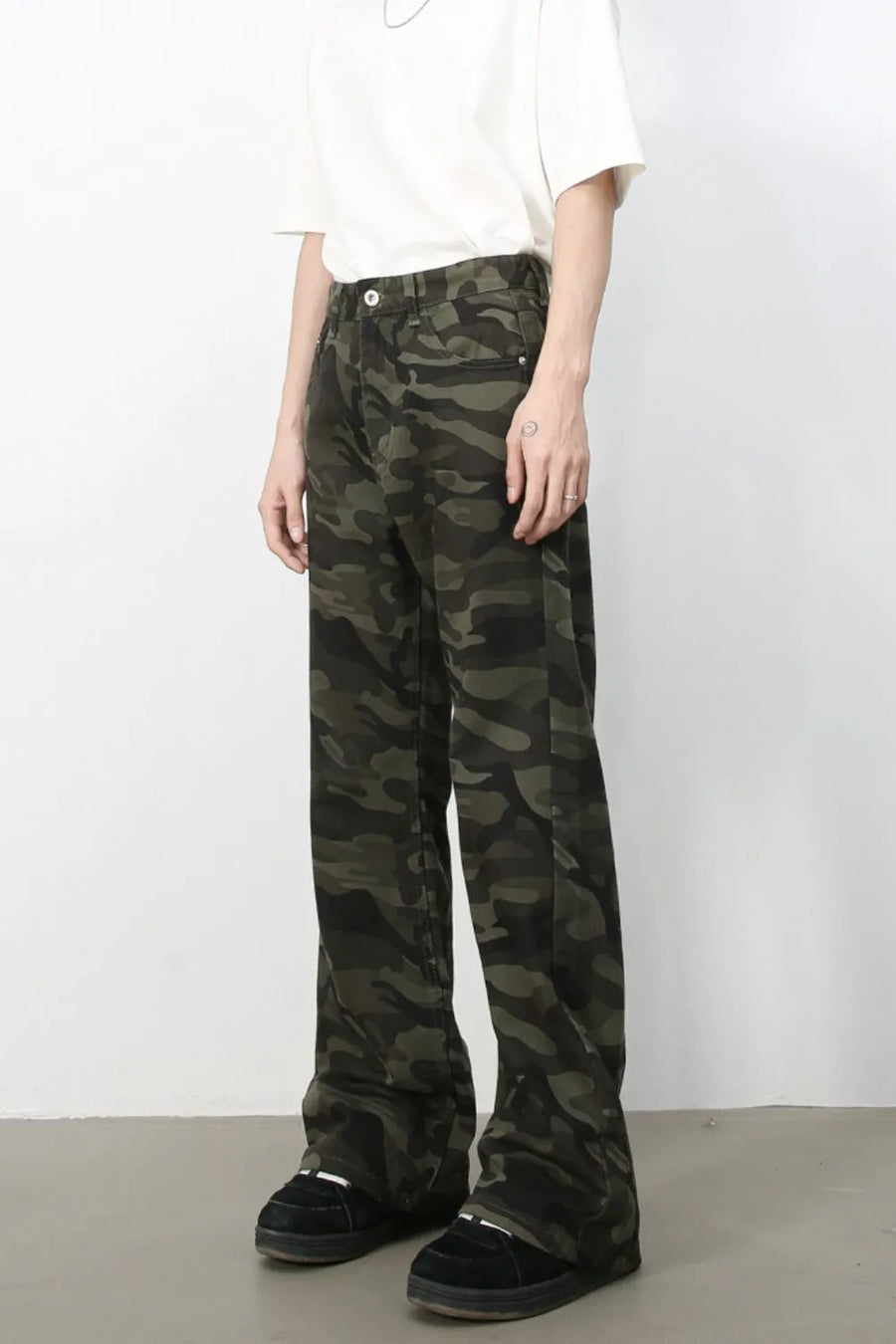 Camo flare denim trousers in green camouflage pattern, featuring a casual, breathable fit.