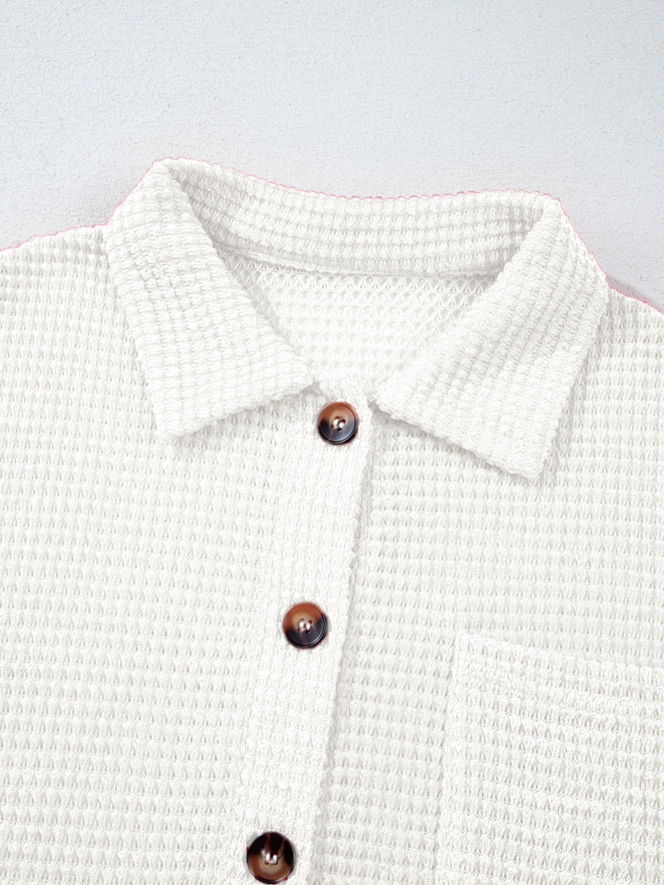 White waffle knit button-up shirt with chest pocket and brown buttons.