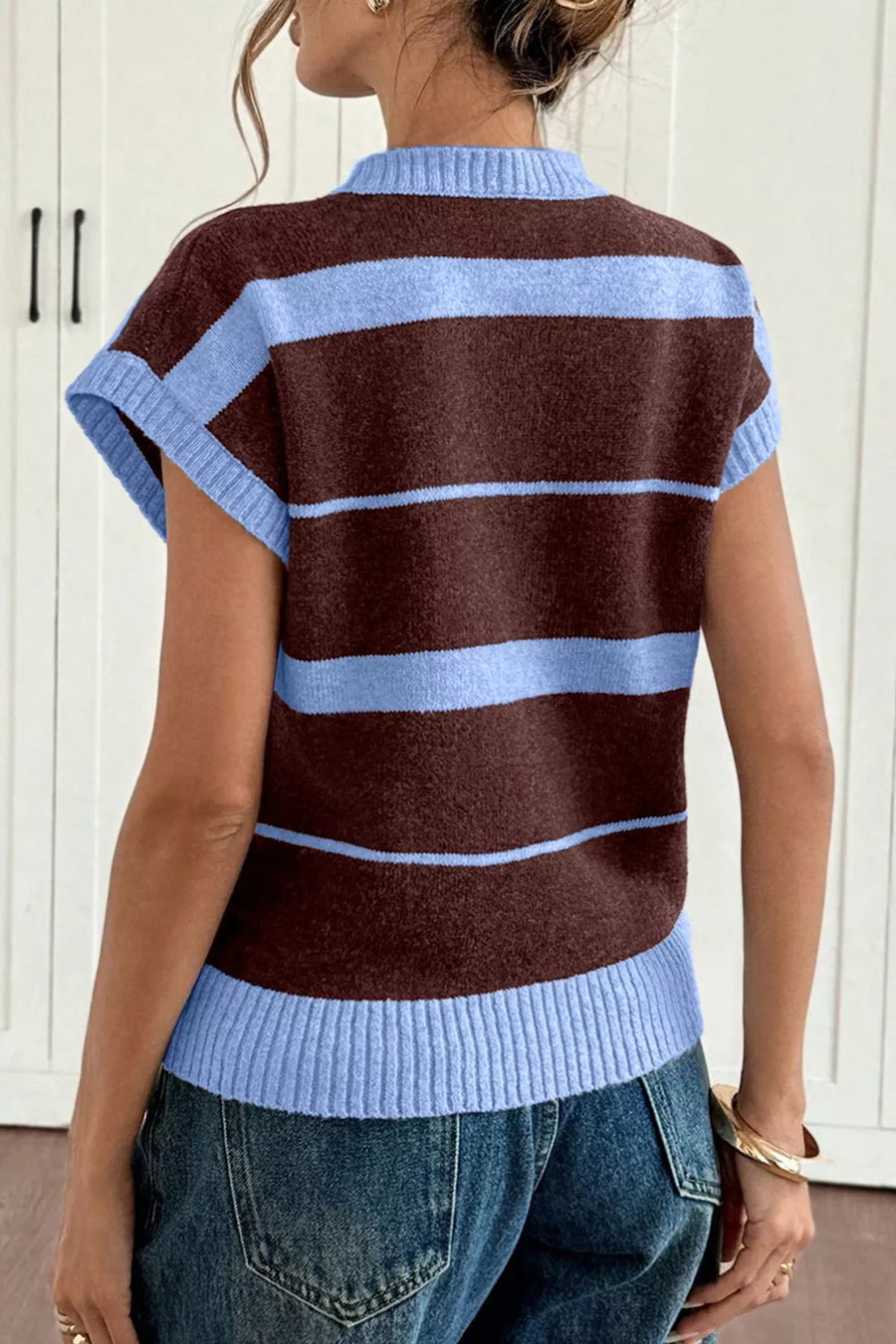 Brown and blue striped knit sweater vest with ribbed crew neck and hem.