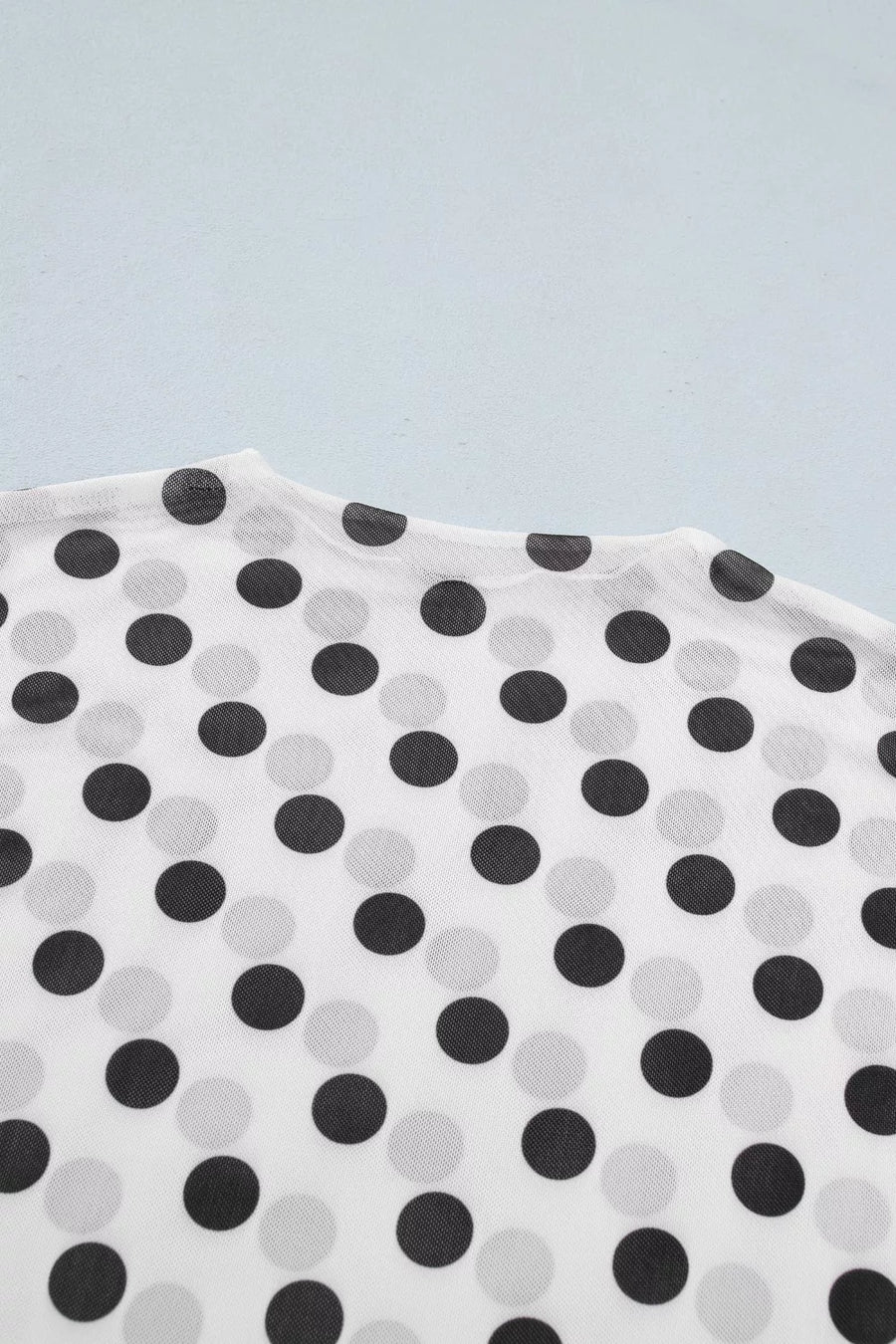 White polka dot mesh mock neck maternity shirt with sheer fabric.