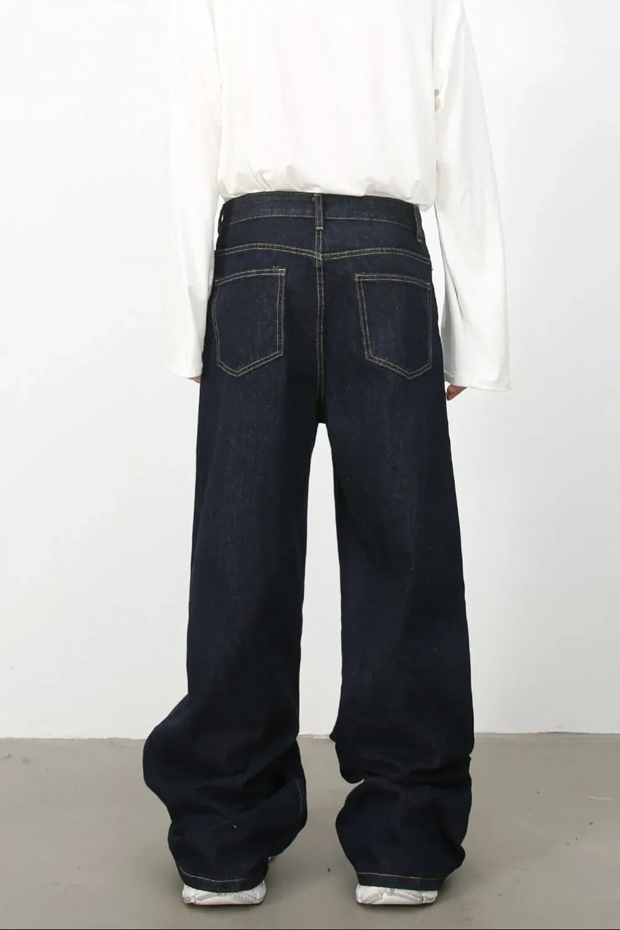 Dark denim trousers with sculptural seam detail and wide leg