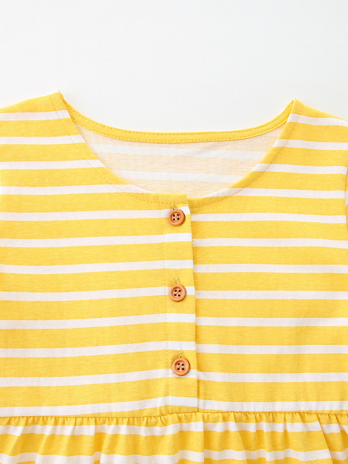 Yellow and white striped cotton toddler dress with wooden buttons and ruffled hem.