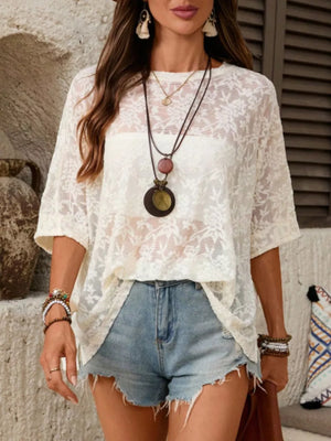 White floral lace sheer blouse with lace trim and short sleeves.