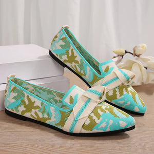 Knitted pointed flats in pastel blue and green camouflage with a cream bow detail.
