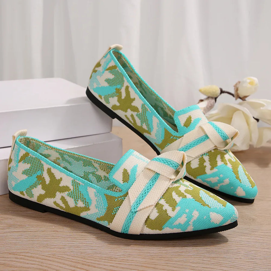 Knitted pointed flats in pastel blue and green camouflage with a cream bow detail.