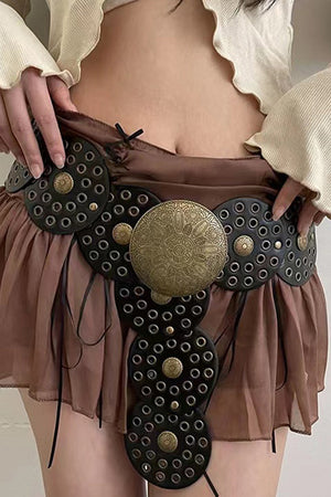 Embossed medallion and studded black belt with alloy details, styled casually.
