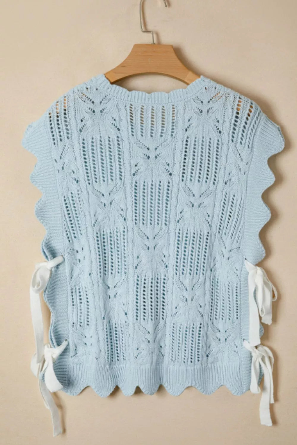 Light blue openwork cable-knit cardigan with cap sleeves and tie details