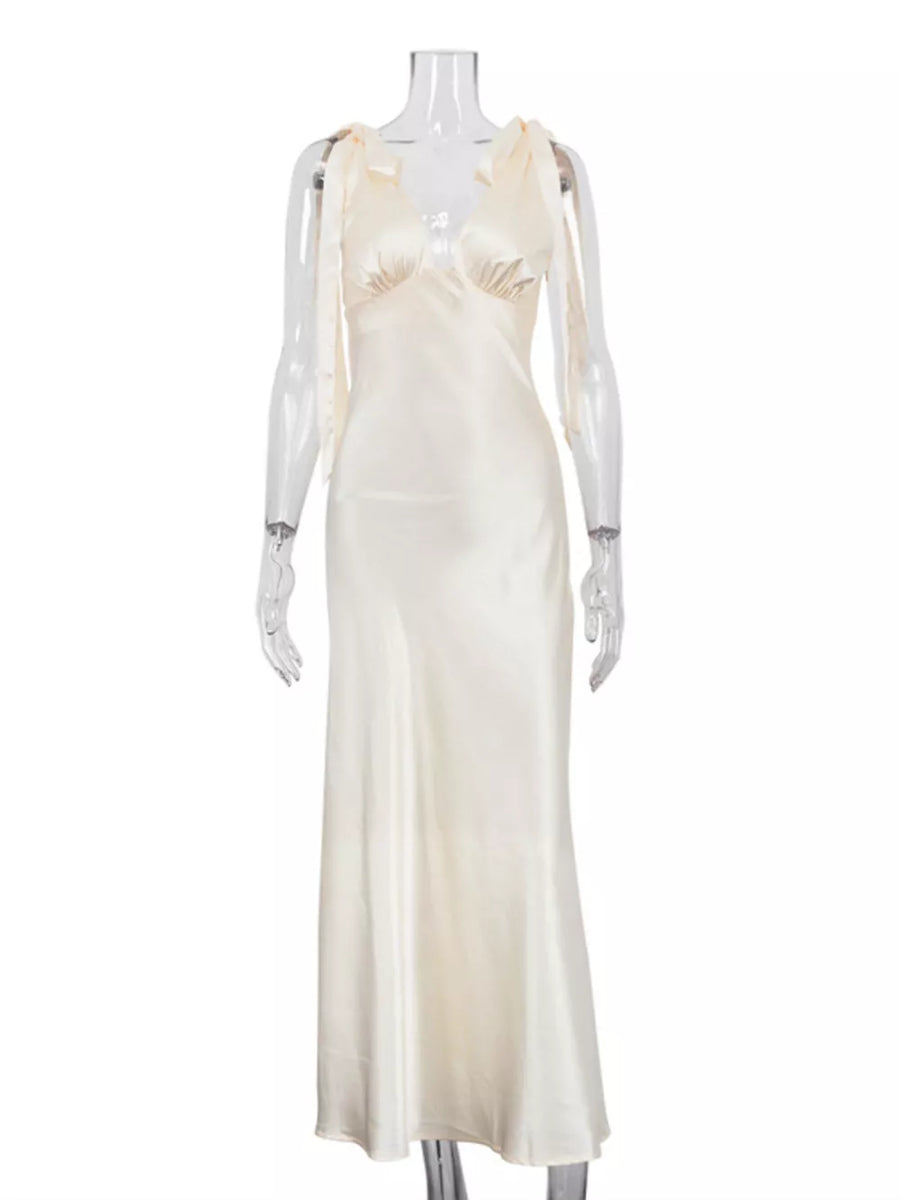 Cream satin slip dress with tie shoulder straps and a V-neckline.