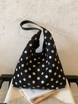 white handbag featuring pocketed and polka-dot