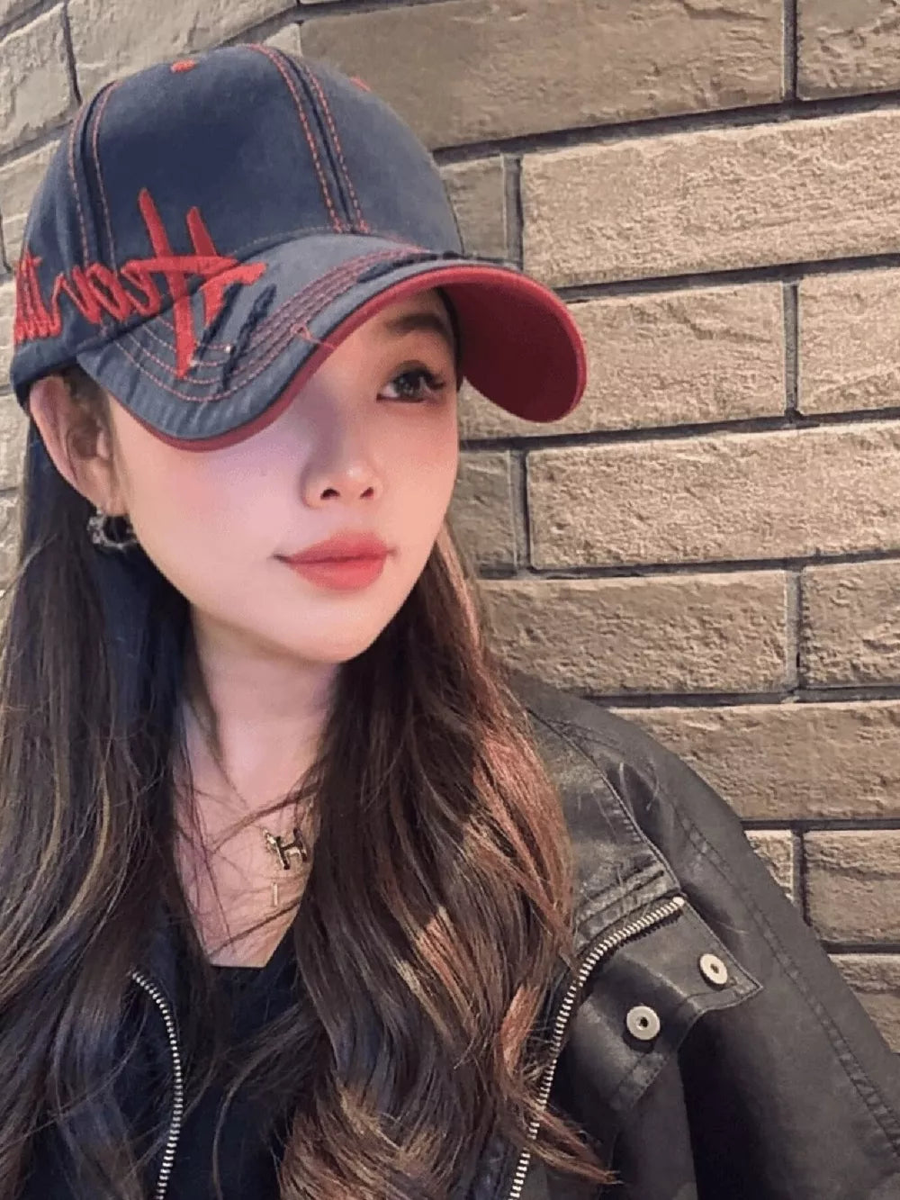 Navy cotton baseball cap with red embroidery and contrast stitching, red brim lining.